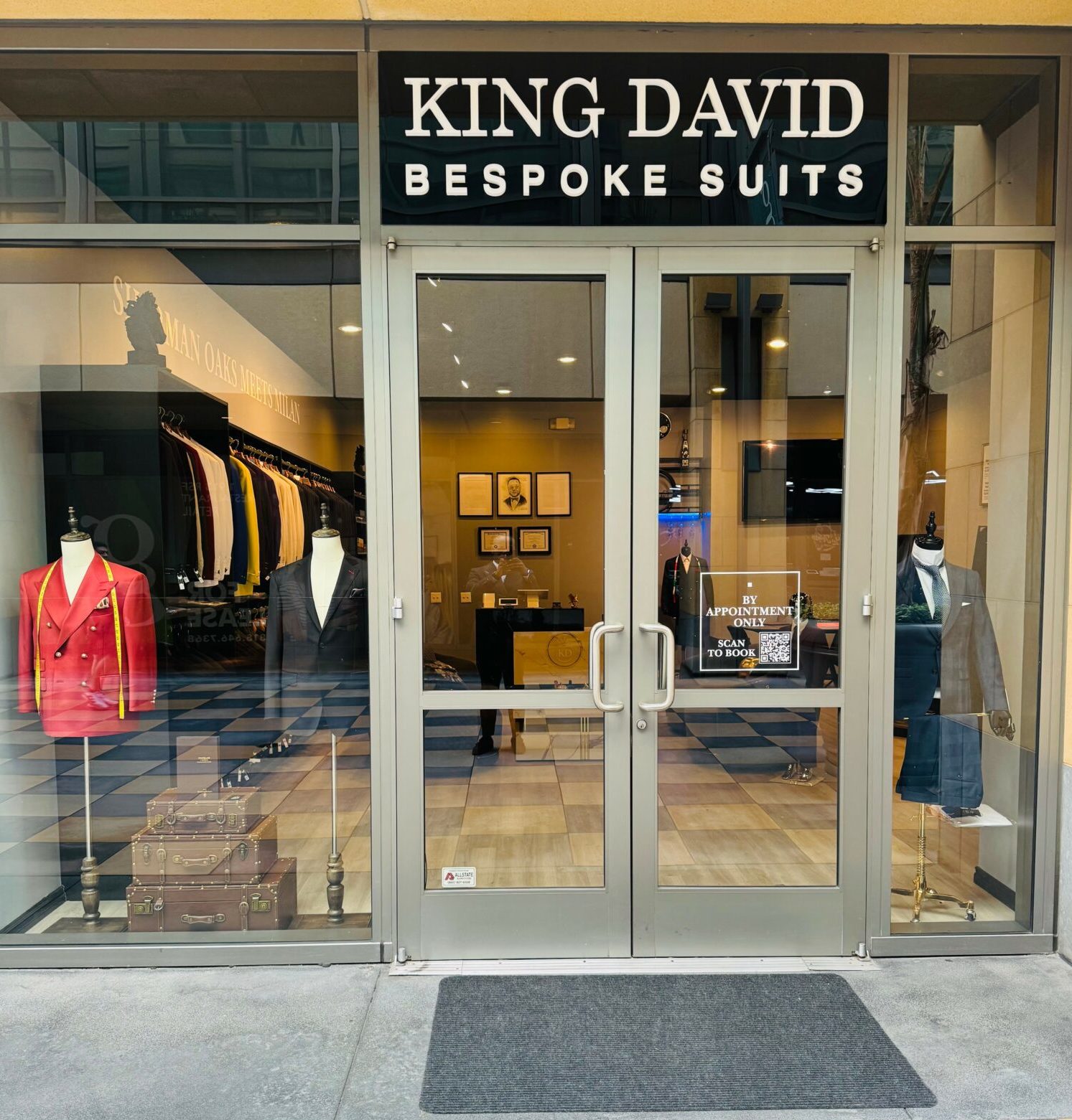 King David Bespoke Suits storefront with owner standing at entrance